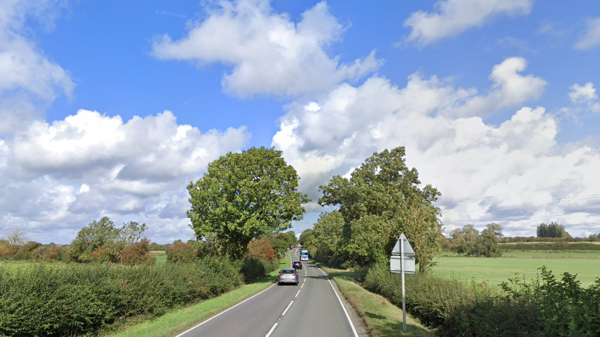 The A5199 with trees and bushes on either side of the road 