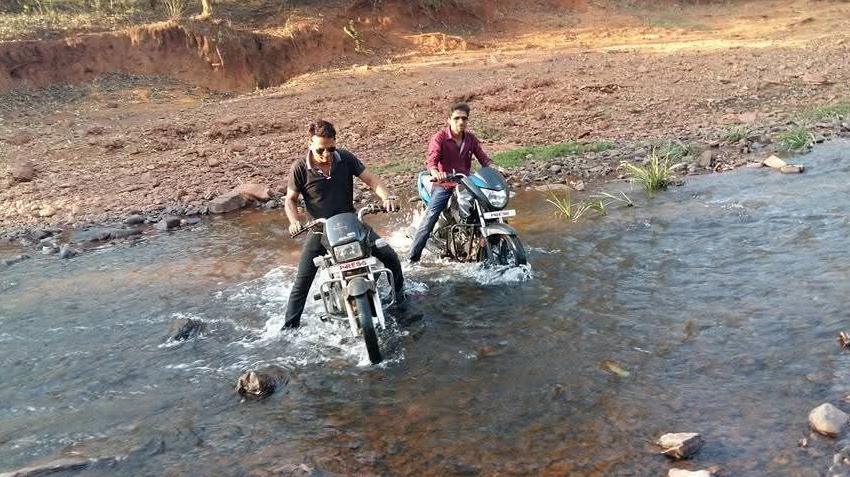 Ganesh Mishra (left) and Mukesh Chandrakar navigating difficult terrain on bikes while on their way to report a story