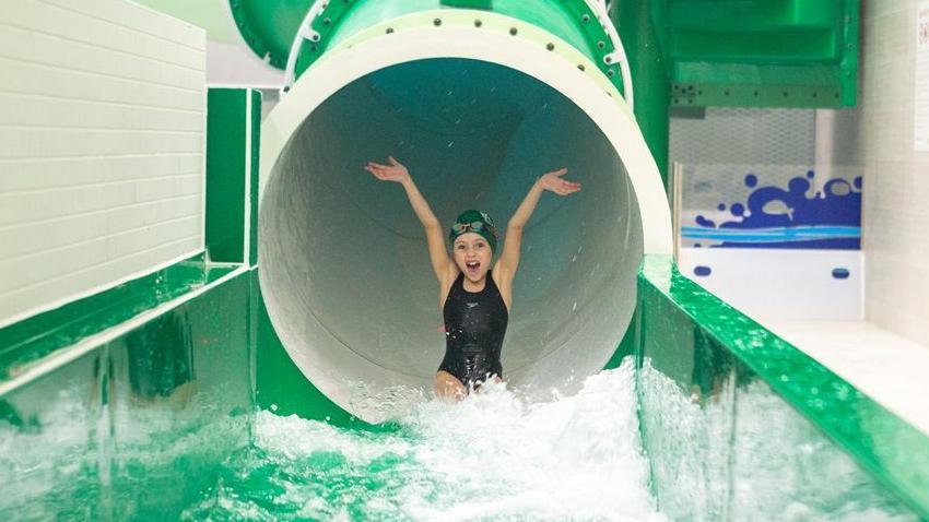 A child on a pool flume ride