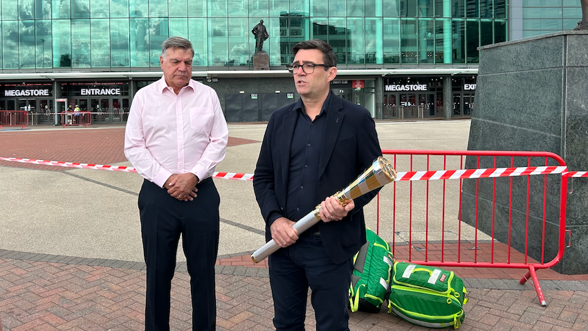 Sam Allardyce and Andy Burnham, who is holding the Baton of Hope, outside Old Trafford.