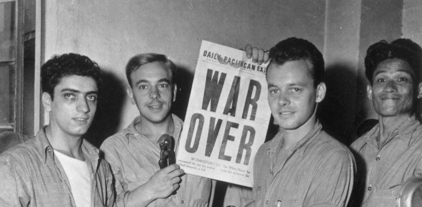 Men at a naval base in the Philippines celebrate at the end of the World War II.