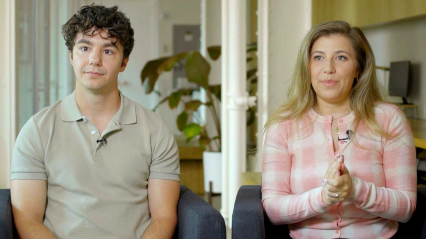 Paul Skye Lehrman and Linnea Sage, who claim their voices were stolen, sit in armchairs with neutral expressions.