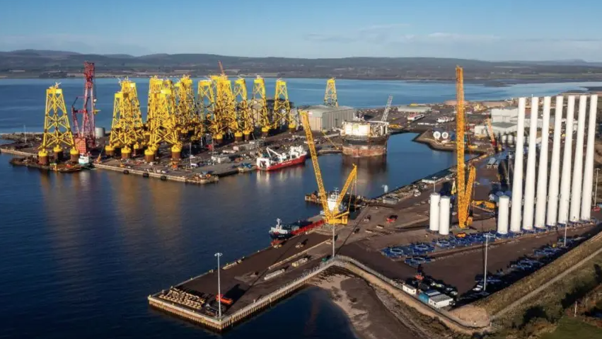 A general view of the Port of Nigg from above showing machinery on platforms in the water and a number of boats moored nearby.