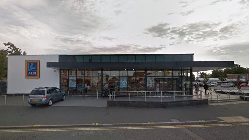 Glass and brick supermarket with pavement outside