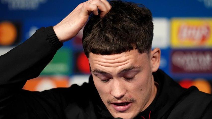 Liverpool's Florian Wirtz speaks at a new conference before his side's Champions League quarter-final against Paris St-Germain in the French capital