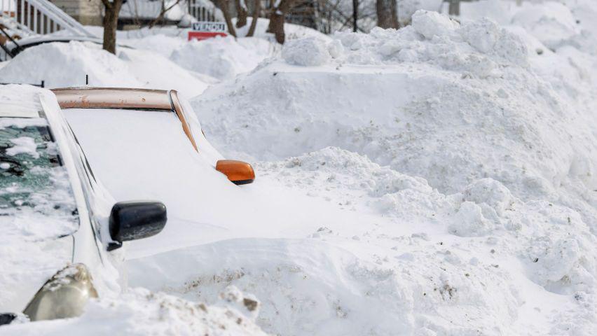 Cars under snow following snow storms in Canada