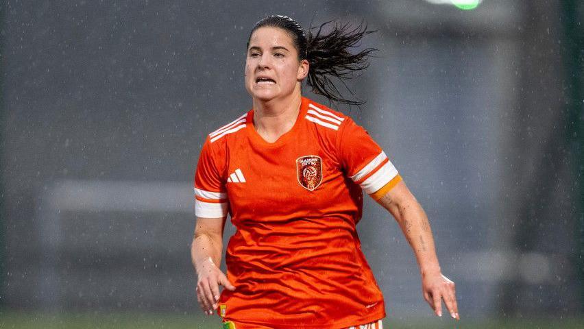 Nicole Kozlova runs in the rain