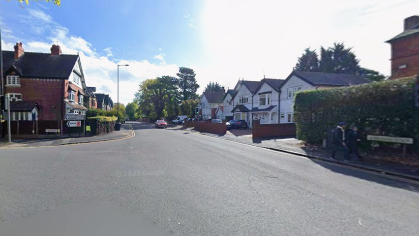 A junction of two roads in a residential area.