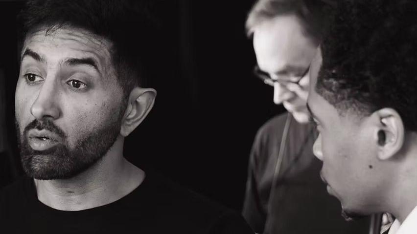 Another shot of Sethi directing on set. An actor looks to him for guidance.