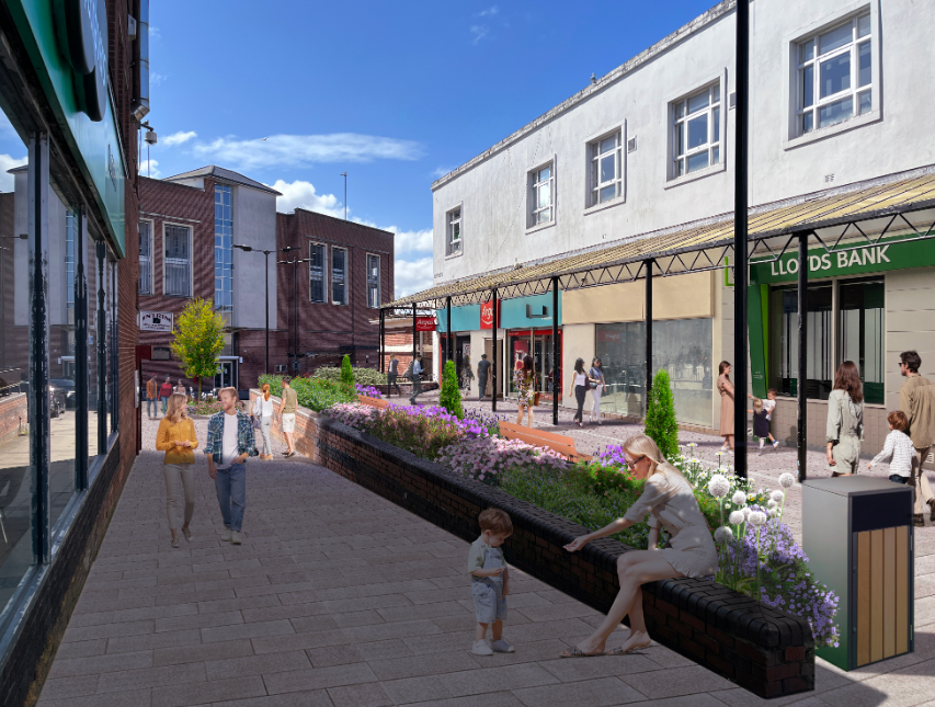 An artist's impression of Workington public realm improvements. A white stone street has a long flower bed running down the middle of it. A veranda is superimposed above the shop front.