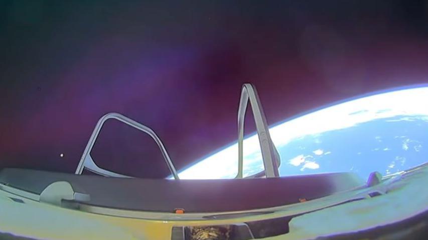 The earth can be seen as a huge blue semi-circle from a CCTV camera on the outside of the SpaceX capsule.