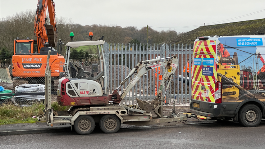 Wessex Water vehicles on site to fix the burst water main