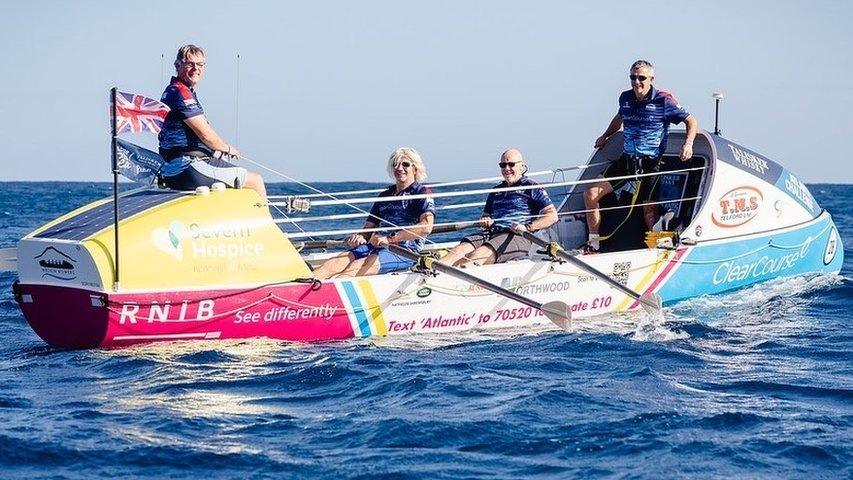 Four men in a rowing boat in the Atlantic Ocean.