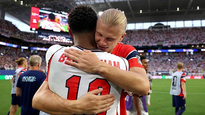 Erling Haaland hugs Jude Bellingham