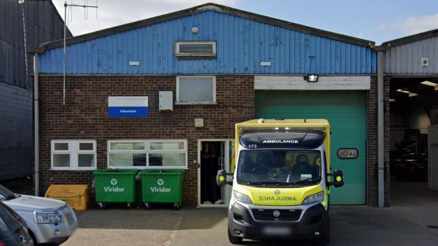 An ambulance parked outside an ambulance station