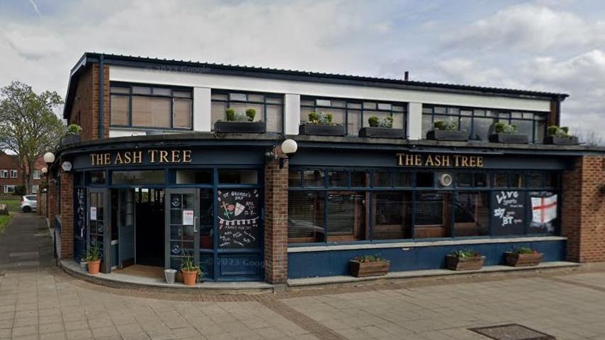 Outside of the Ashe Tree pub in Ashford. A blue pub with a white top floor.