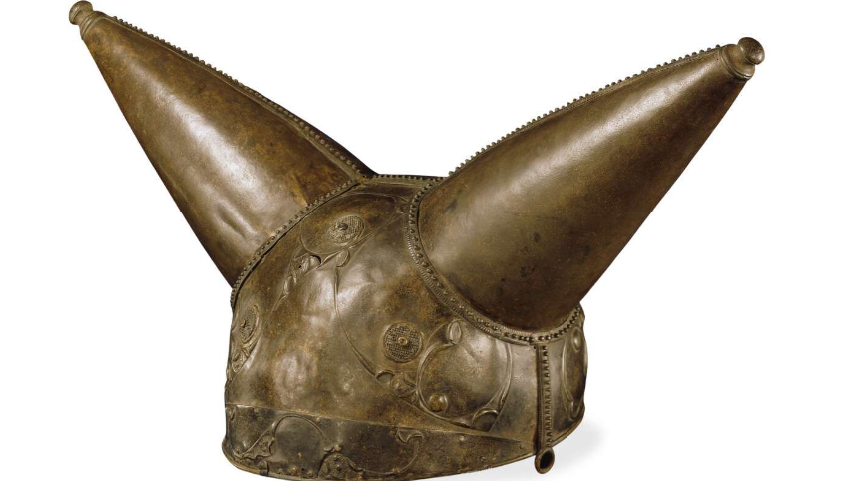 A metal helmet with two metal cones on top like horns. Engraved as decoration