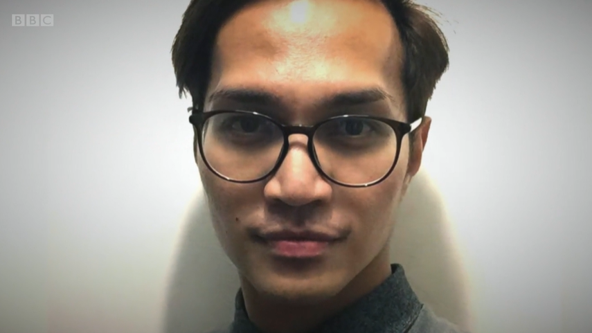 Reynhard Sinaga wears black rimmed glasses and smirks at the camera