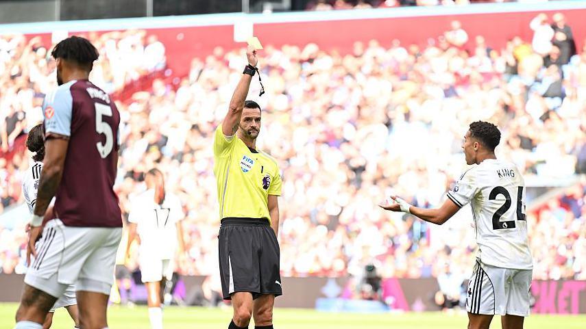 Josh King reacts to be shown a yellow card against Aston Villa