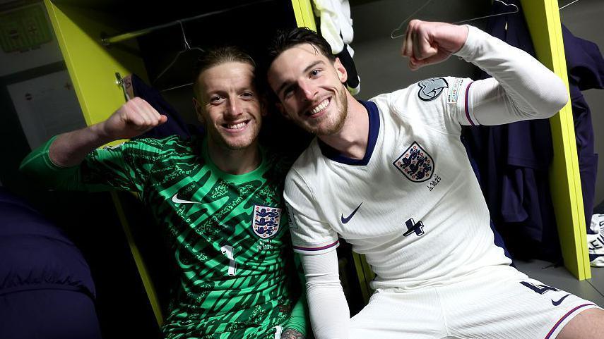 Jordan Pickford and Declan Rice of England celebrate in the dressing room following the FIFA World Cup 2026 qualifier match between Latvia and England