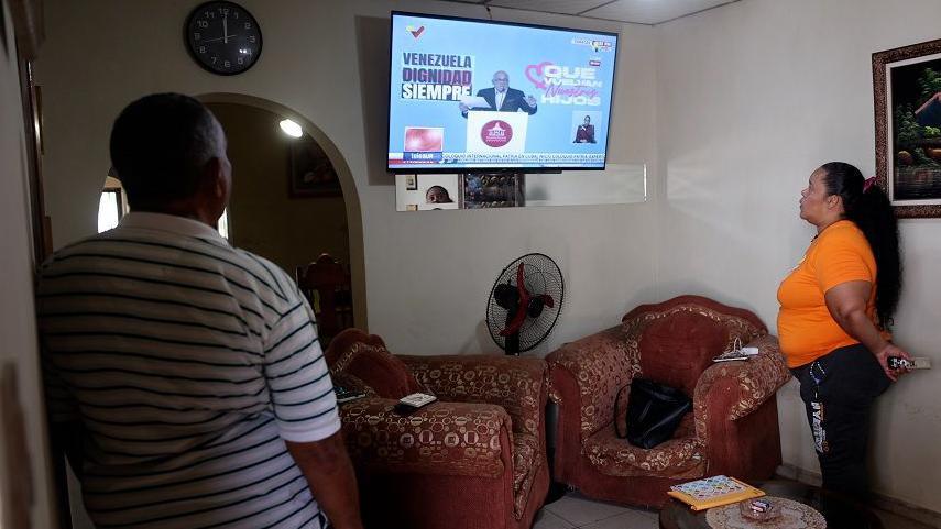 Myrelis Casique López watching television with her family in Maracay, Venezuela. 