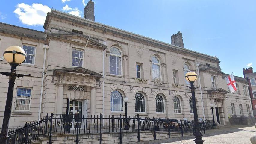 Rotherham Council building flying the flag of St George (right).