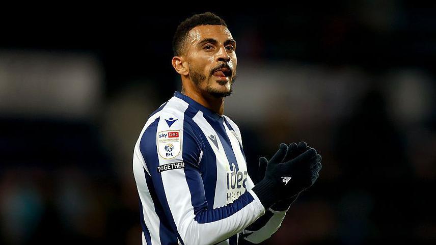 Karlan Grant applauds the fans while playing for West Bromwich Albion