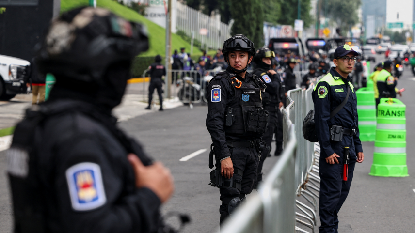 Police near the England team's hotel before their arrival for their World Cup last-16 game with Mexico in Mexico City