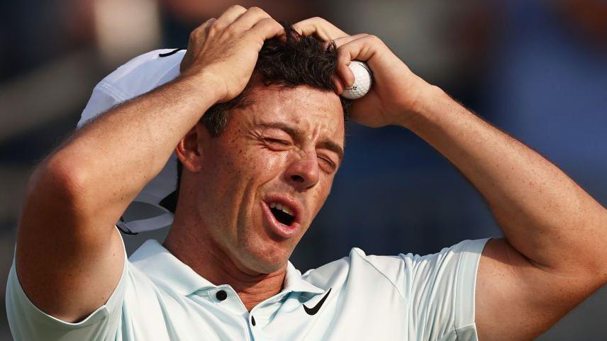 Rory McIlroy winces after missing a putt