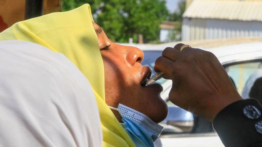 An image of a woman receiving a vaccination for cholera 