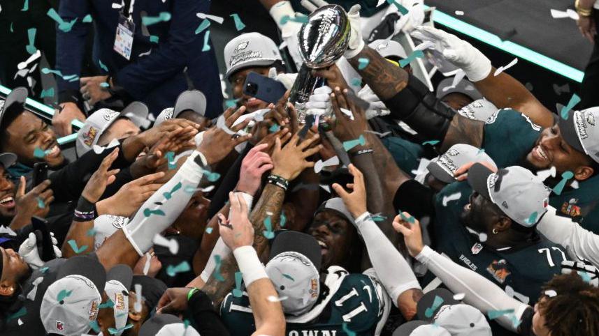 Philadelphia Eagles players celebrate with the trophy at the end of Super Bowl game in New Orleans, Louisiana, on 09 February 