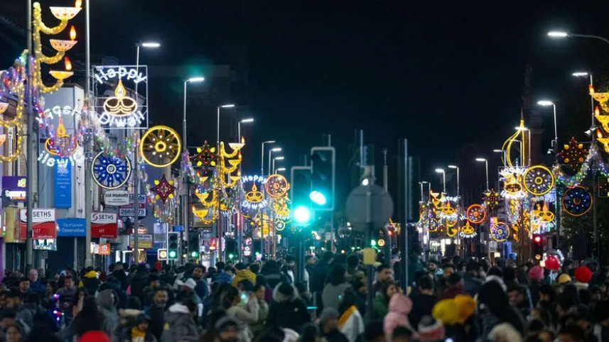 Belgrave Road in Leicester at Diwali with Diwali lights lit-up and hundreds of people celebrating