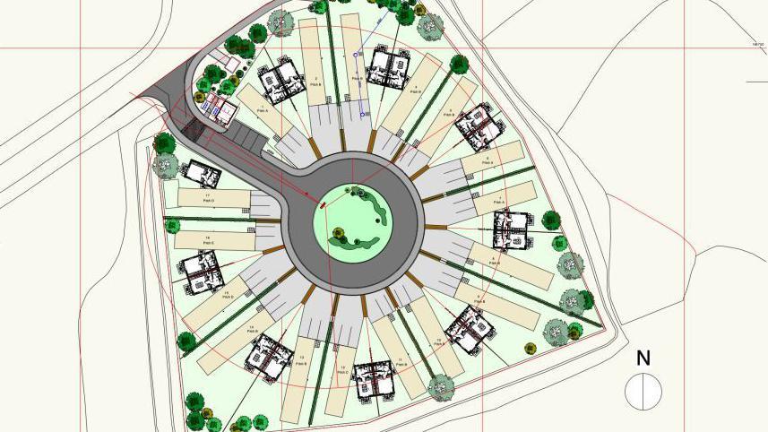 A drawing shows the layout of the upgraded site from overheard. 17 caravans are arranged in a circle of eight pairs and one on it's own next to the entrance to the site. All sites have driveways and areas for parking vehicles and in the centre an area of greenery is indicated