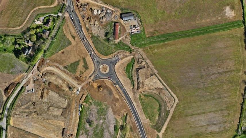 Aerial shot of new road with roundabout and construction site