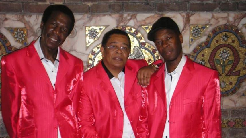 Leon Leiffer and two other members of The Blackstones wearing white shirts and bright red jackets