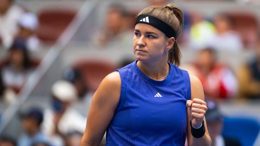 Karolina Muchova holds up her fist in celebration