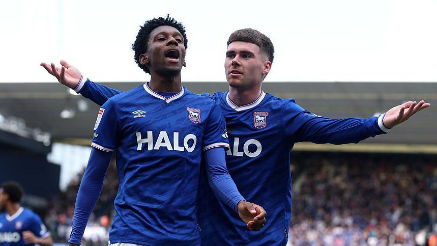 Jaden Philogene and Leif Davis, both in blue Ipswich Town shirts celebrate Philogene's goal against Norwich earlier this season
