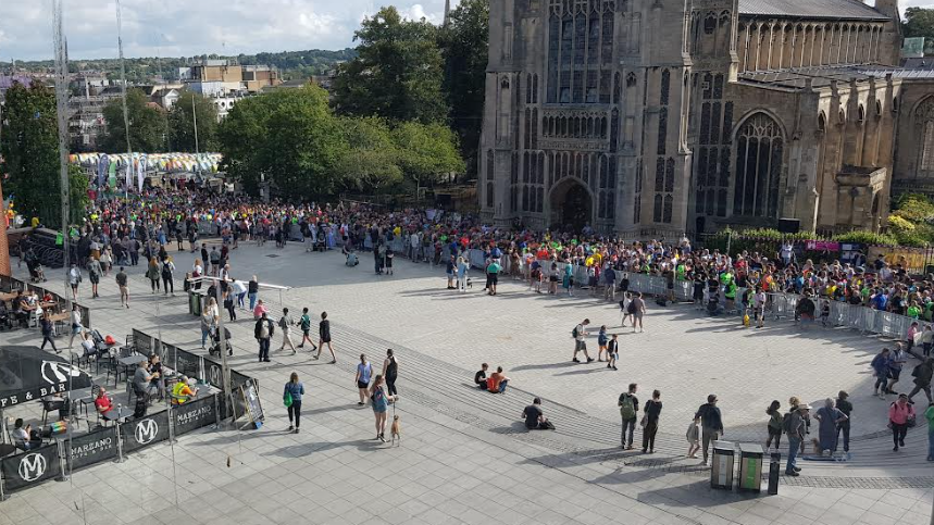 Thousands of runners lining up for the start of the race outside The Forum with St Peter Mancroft church in the background