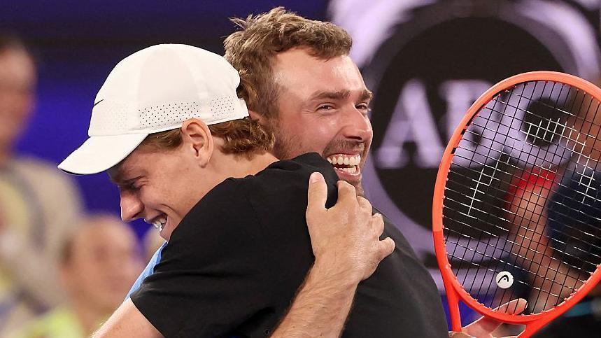 Amateur player Jordan Smith hugs Australian Open champion Jannik Sinner after beating him in the One Point Slam