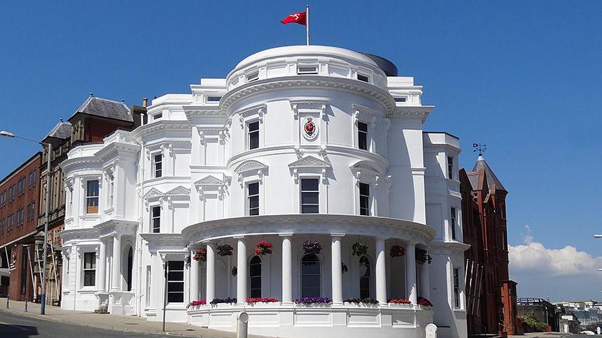 The Isle of Man's parliamentary buildings. Known as the Wedding Cake building, it is a round, white three-tiered building.