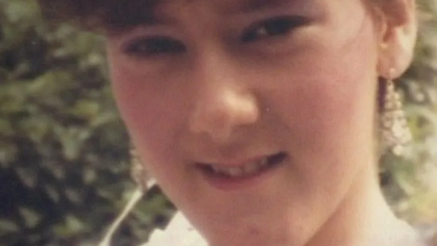 Julie Hogg. A young woman with brown hair smiles at the camera