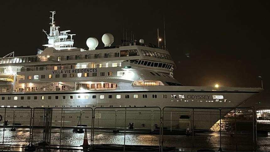 A large white ship in dark waters