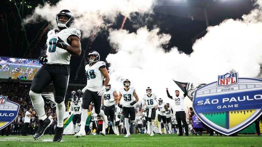 Philadelphia Eagles players run out before their game with the Green Bay Packers in Brazil