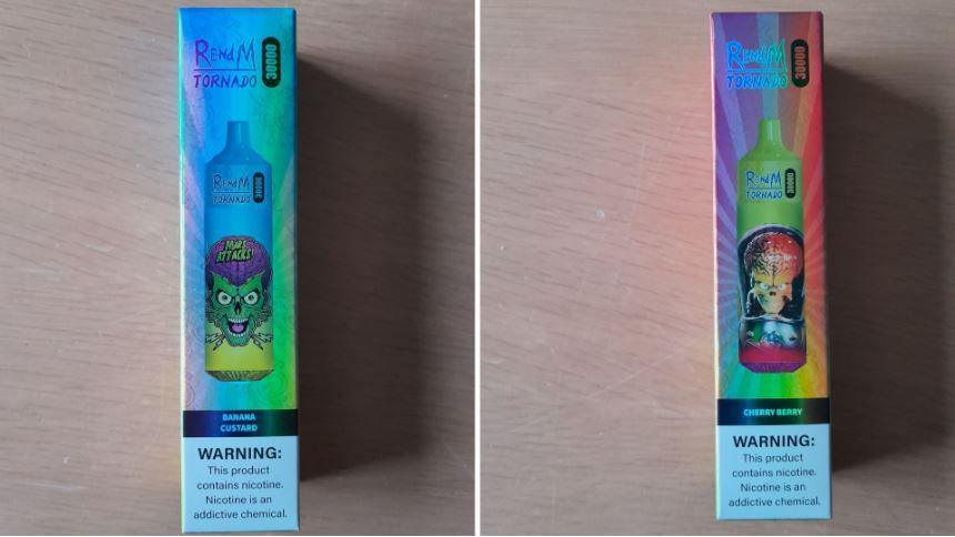 Two photos of super vapes. One has packaging with a monster's face on, and it is blue and green. The one on the right also has a monster's face, but the packaging is purple, red, yellow and green.