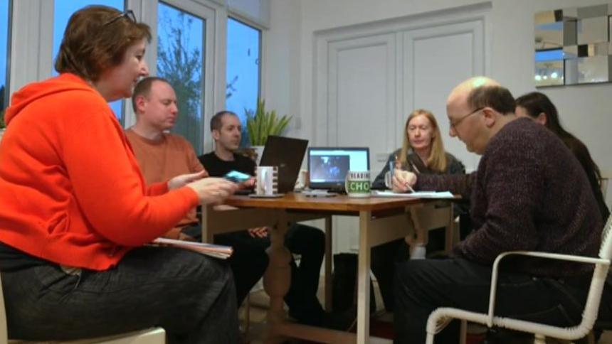 A group of volunteers round a table