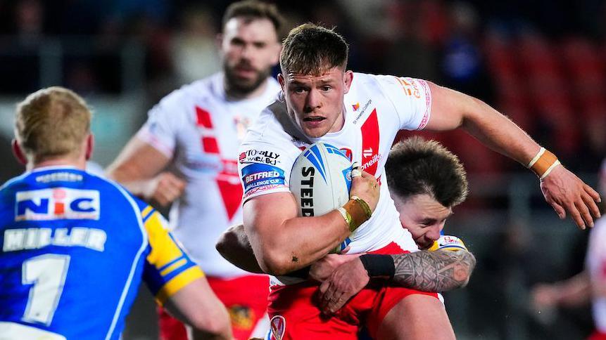 Morgan Knowles of St Helens is tackled by Andy Ackers of Leeds at The Totally Wicked Stadium