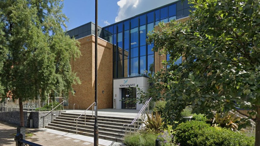 York House, Windsor - a glass and brick-fronted building fronted by trees and a short flight of steps