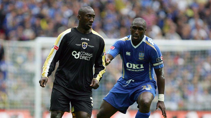 Jimmy Floyd Hasselbaink (L) battles with Portsmouth's Sol Campbell