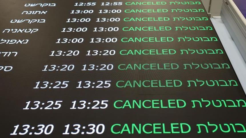 Departure board at airport in Israel showing cancelled flights