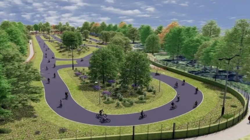 A computer-generated picture of the new hub showing a long, oval grey track with cyclists on it, surrounded by lots of trees